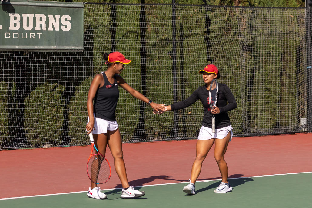 Senior Salma Ewing and junior Eryn Cayetano give each other a high five during USC's victory over CSUN Tuesday.
