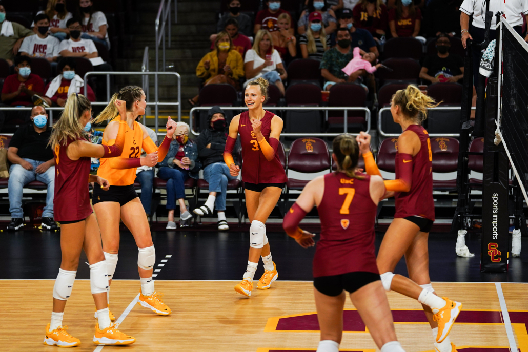 Emilia Weske and her teammates celebrate during a volleyball match. 
