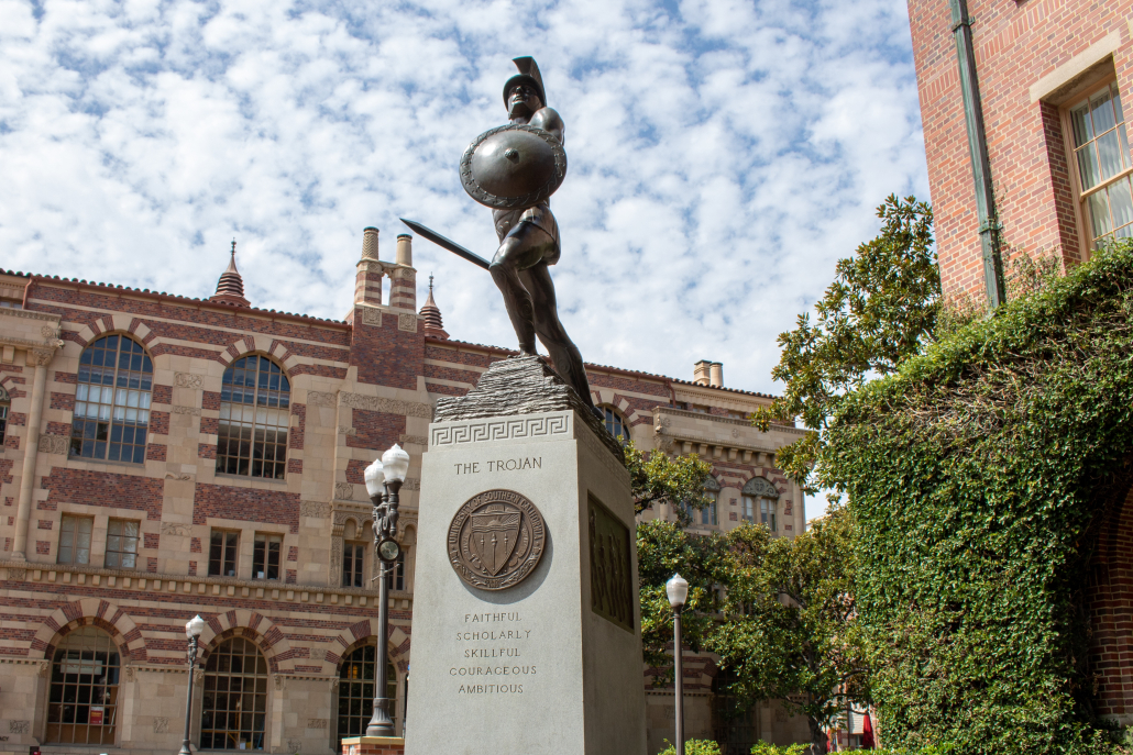 Photo of Tommy Trojan against a cloudy sky.