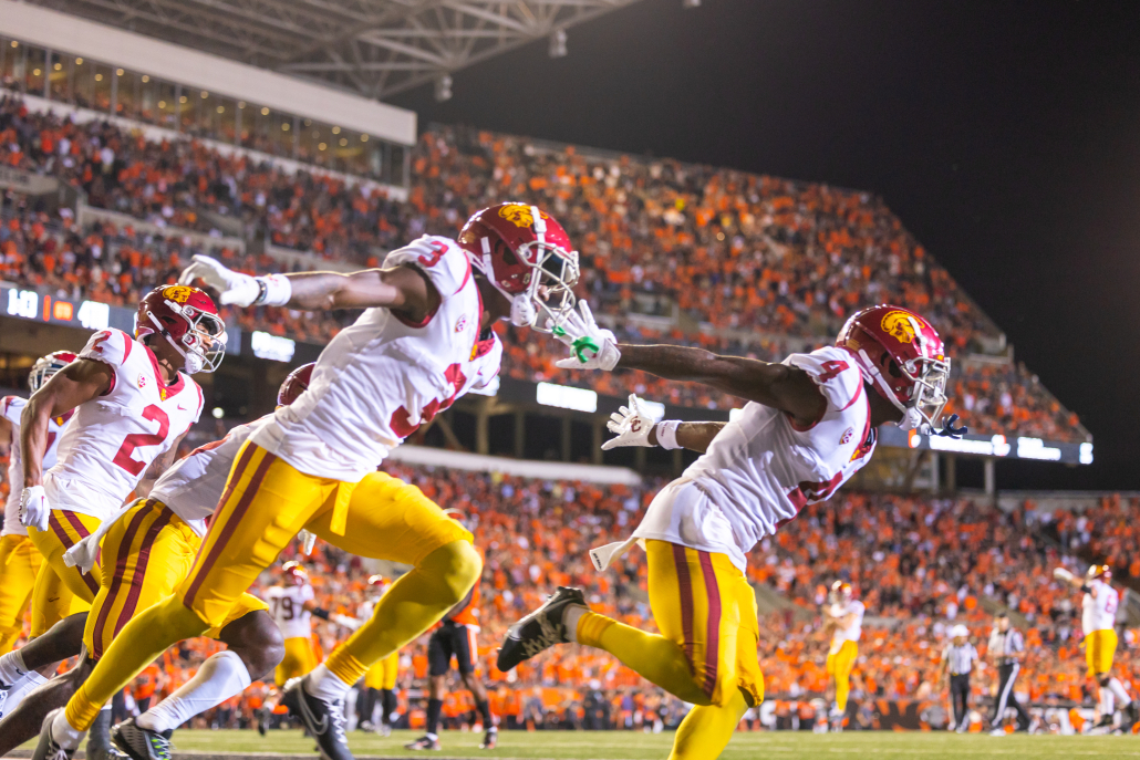 Jordan Addison, Mario Williams and Brendan Rice take the field before USC's win against Oregon State. 