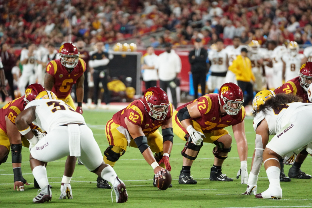 Brett Neilon prepares to snap to Caleb Williams.