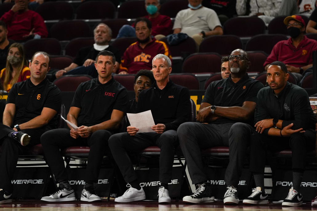 USC basketball coaches sit court-side.