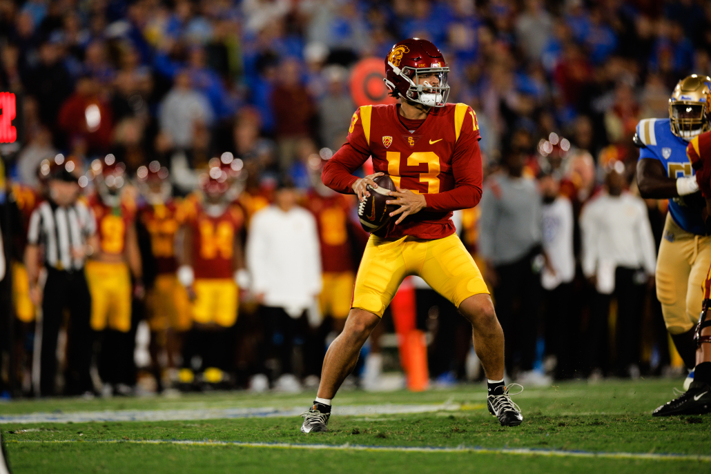 USC quarterback Caleb Williams evades pressure while dropping back to throw the ball against UCLA.