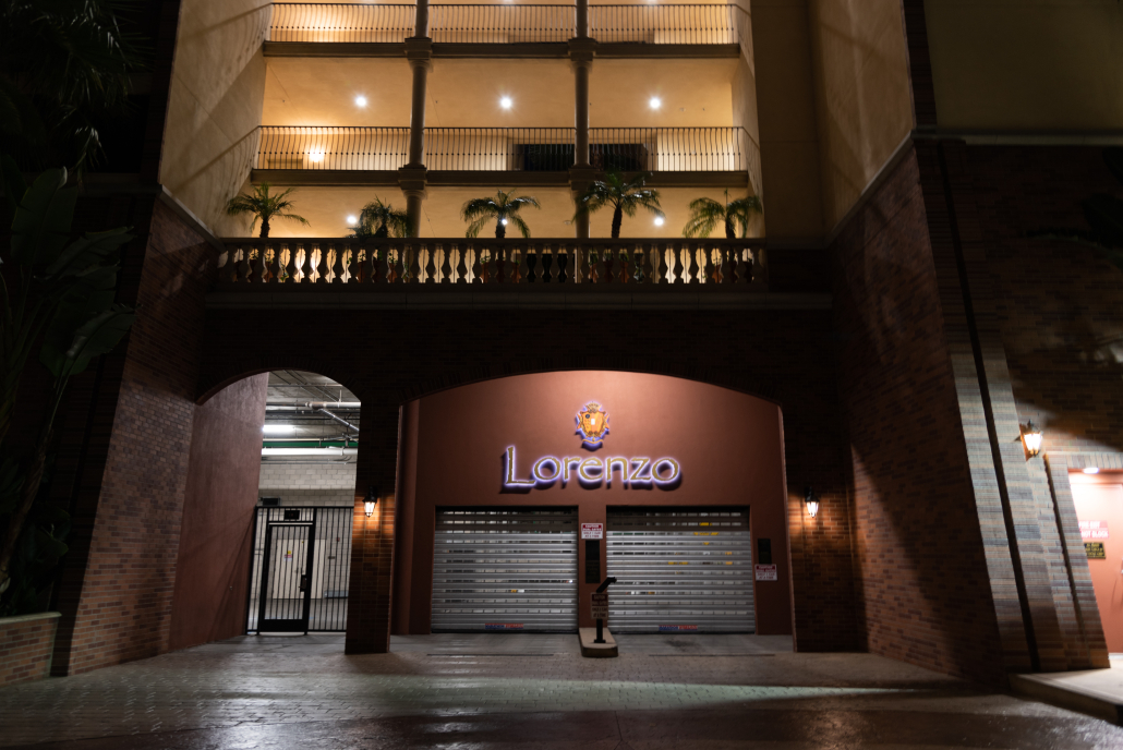 The garage of The Lorenzo at night, shining out from the building's dark facade.