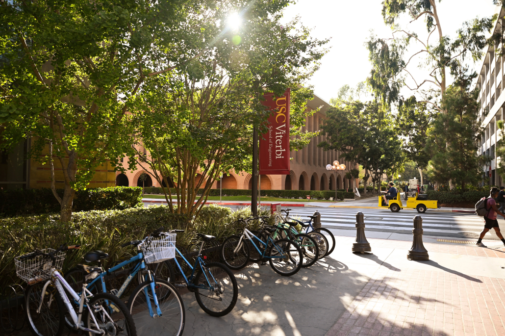 A view of a bike rack and flag reading "USC Viterbi" on the University Park Campus.