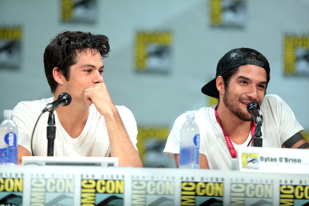 Dylan O'Brien and Tyler Posey sitting with microphones.