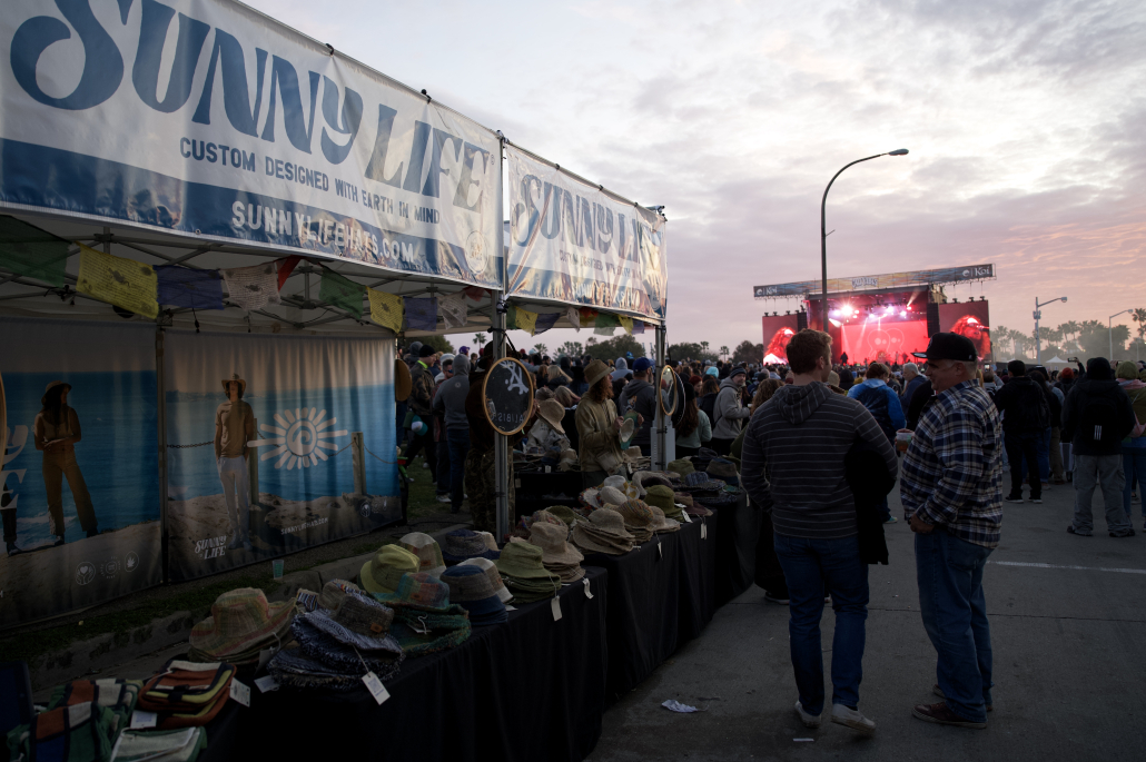 Two canopies read Sunny Life, over an array of hemp hat.