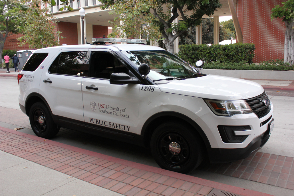 A Department of Public Safety vehicle parked on campus. The vehicle is a white Ford with various identification marks.