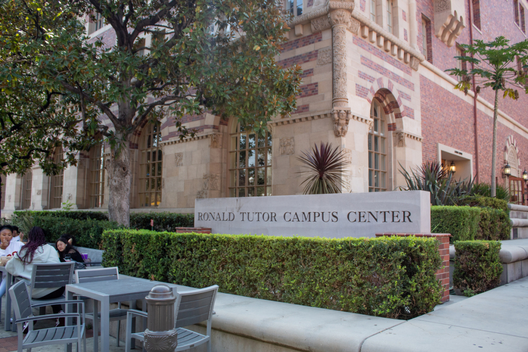 Photo shows the Ronald Tutor Campus Center sign to the left side of the food court. 