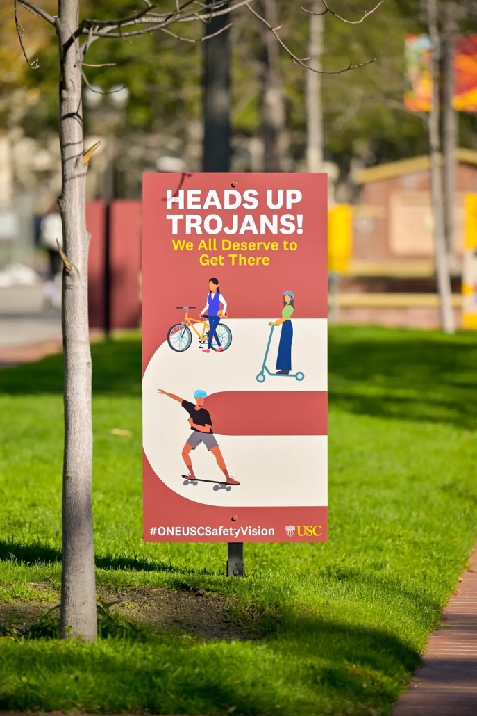 Red sign on Trousdale reads, "Heads up trojans! We all deserve to get there." 