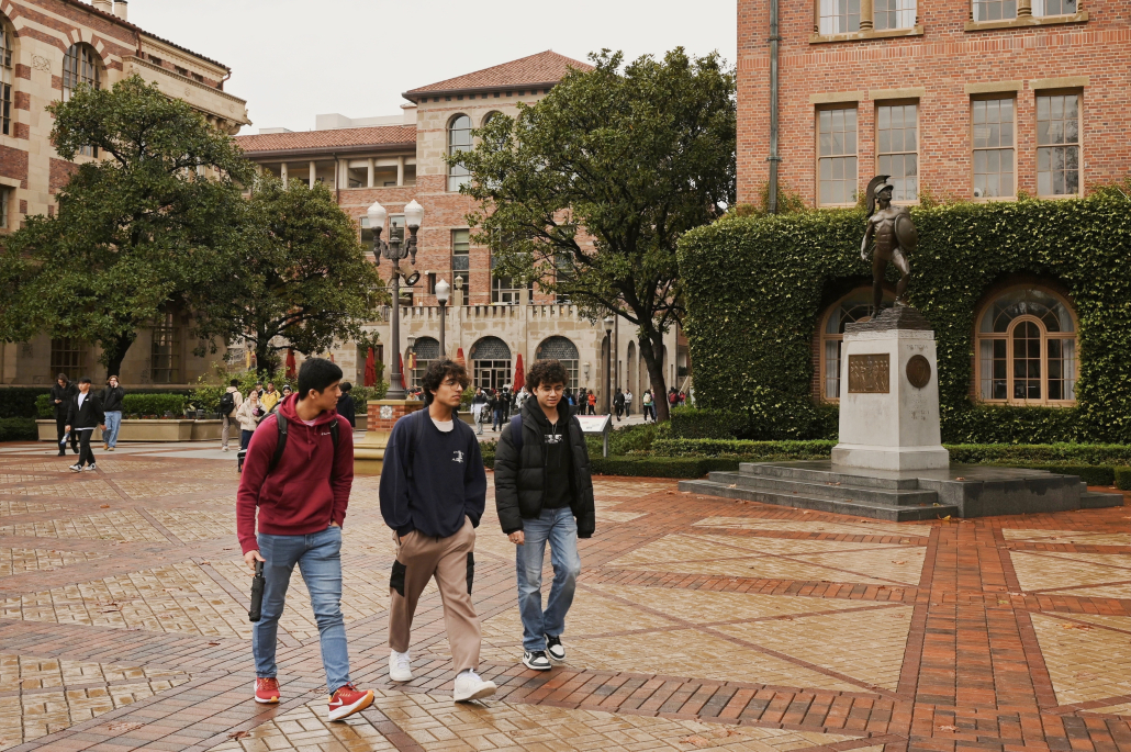 Students walking across a rainy campus.