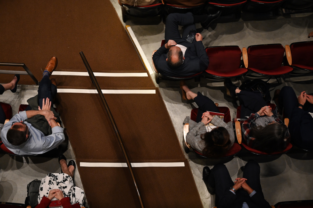 Overhead view of audience sitting in rows of chairs. 