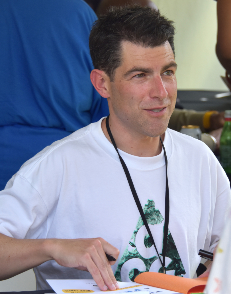 Max Greenfield signs a book