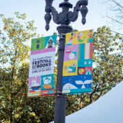 A festival of books banner hangs from a light pole.