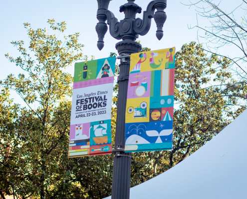 A festival of books banner hangs from a light pole.