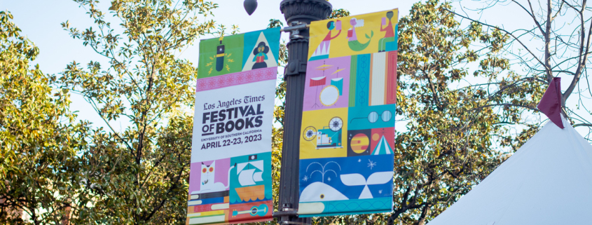 A festival of books banner hangs from a light pole.