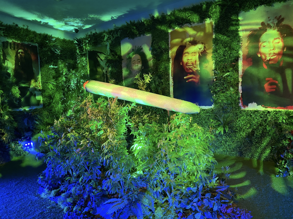A sculpture of a marijuana blunt atop foliage inside the Bob Marley "One Love Experience."