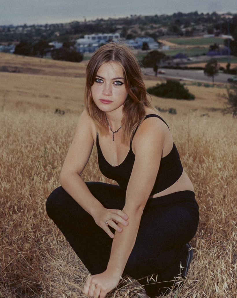 Hailey Wild poses in a field.