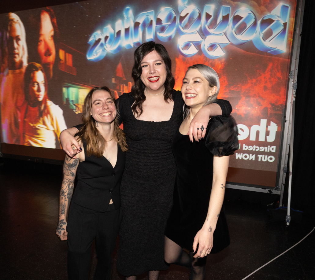 Julien Baker, Lucy Dacus, and Phoebe Bridgers hugging and smiling at "the film" premiere.