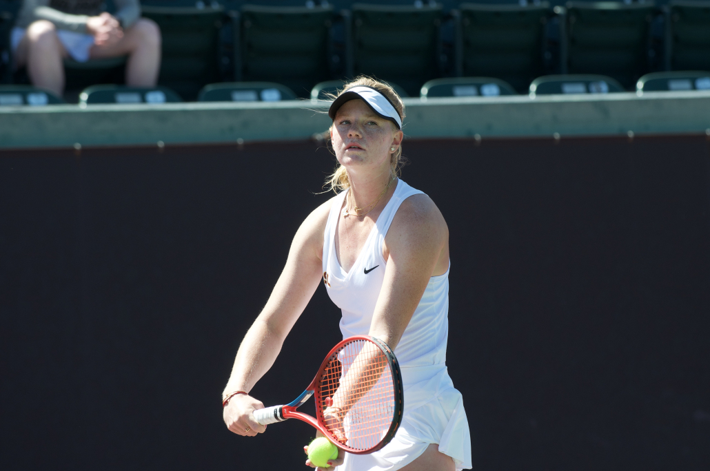 Maddy Sieg has a ball in her hand as she prepares to serve