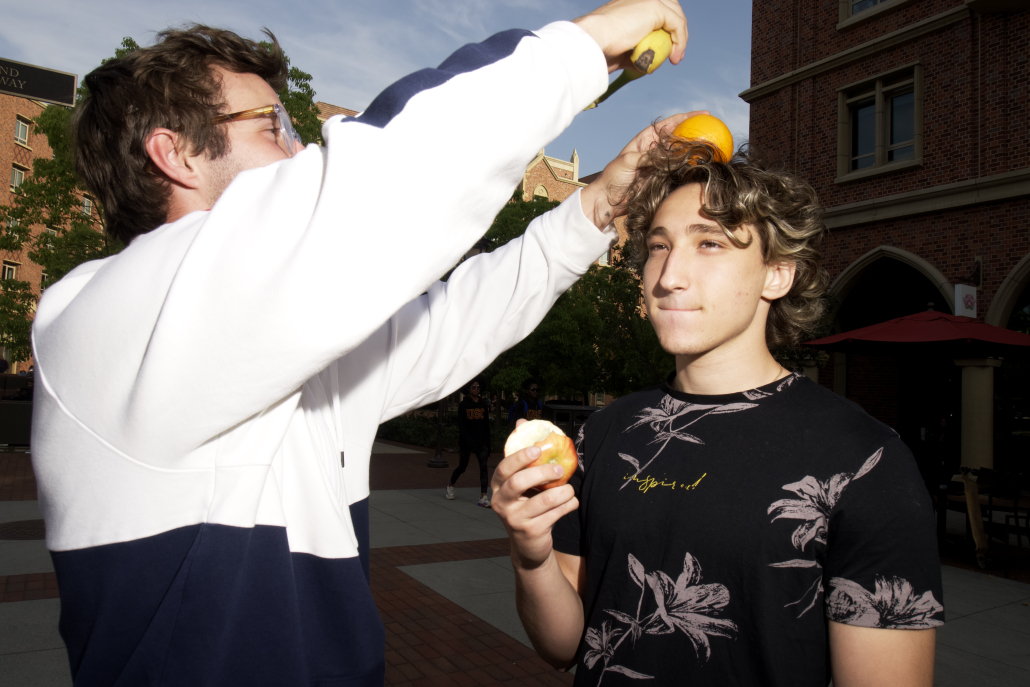 students holding fruit