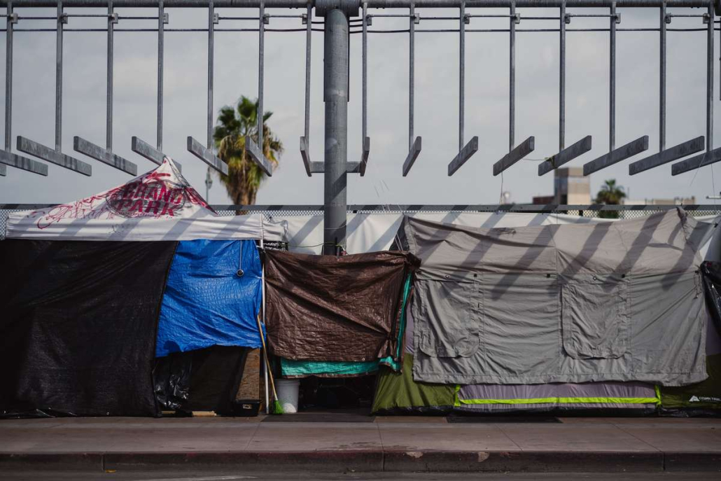 Photo of tents covered in tarps on a street in Los Angeles
