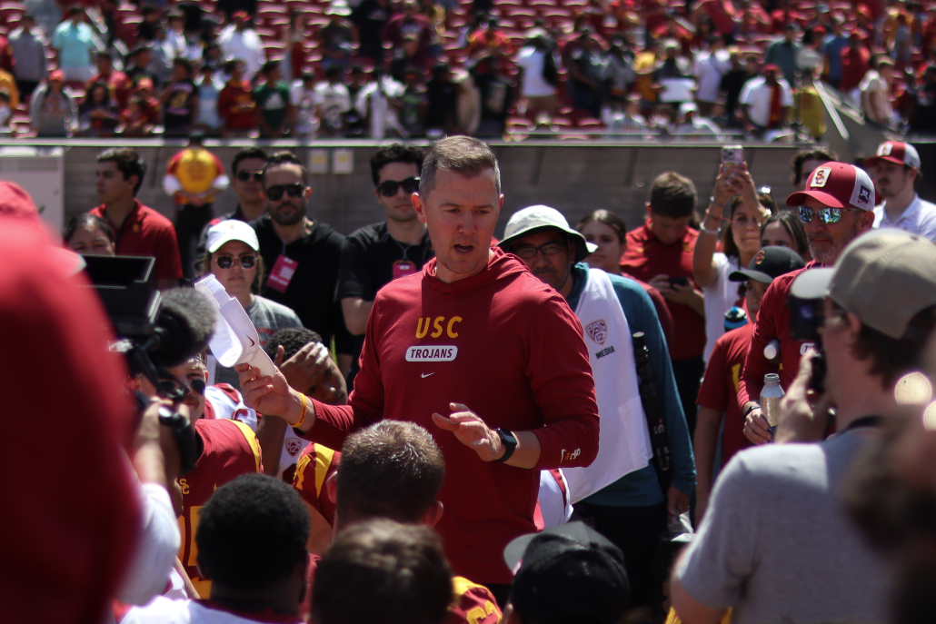 Head Coach Lincoln Riley standing in front of USC football players.