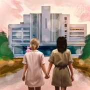 two women walking down a street holding hands.