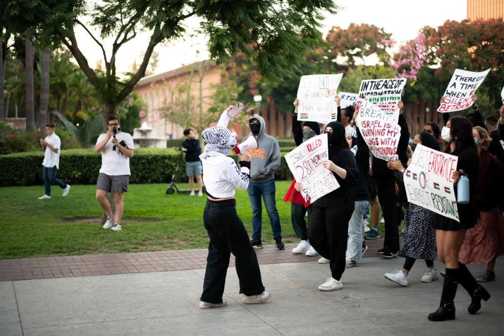 protestors walk across campus
