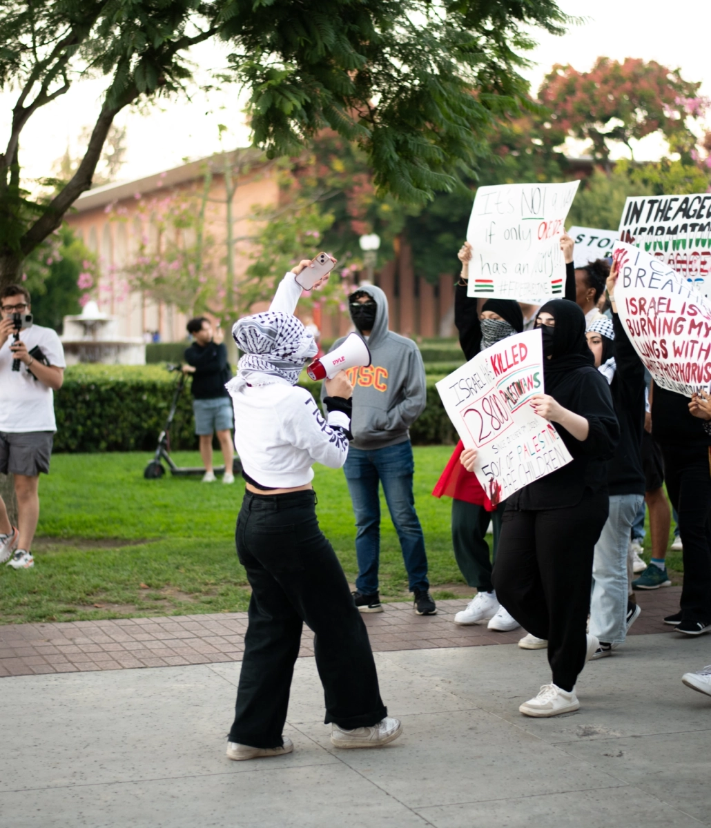 protestors walk across campus