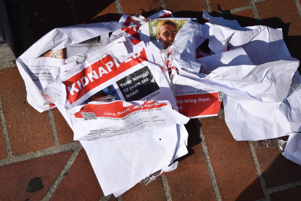 missing posters lie crumpled on the ground