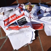 missing posters lie crumpled on the ground