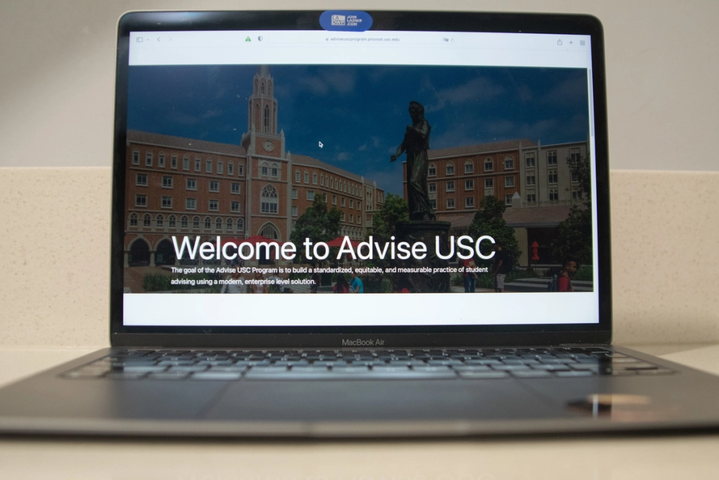Laptop displaying "Welcome to Advise USC"