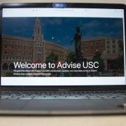 Laptop displaying "Welcome to Advise USC"