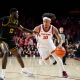 DJ Rodman dribbles the ball while being defended by a Long Beach State player