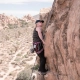 Rock climber scaling a large cliff