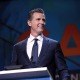 Gavin Newsom at podium, smiling