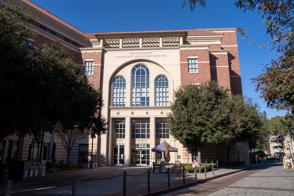 The front of the Engemann Student Health Center, a red brick building with a cream-colored entrance.