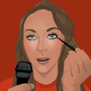 Suzanne Lambert applies makeup and speaks into a microphone.