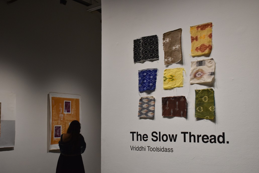 A viewer strolls through "The Slow Thread."