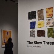 A viewer strolls through "The Slow Thread."