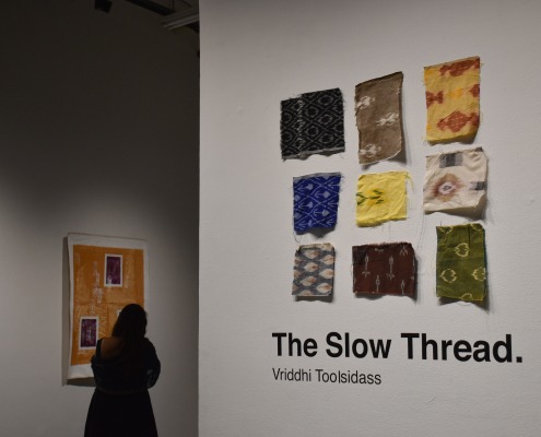 A viewer strolls through "The Slow Thread."