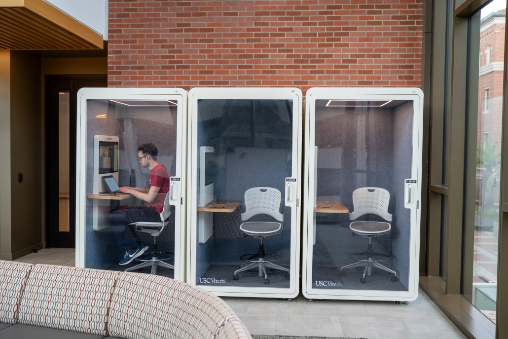 A student stares at his laptop inside one of Ginsburg Hall's study rooms.