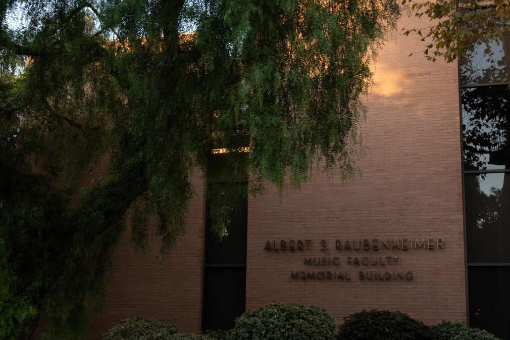 A tree covers the left side of the picture, which shows the Raubenheimer Music Faculty Memorial Building, part of the Thornton School of Music.