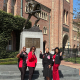 A group of active Delta Sigma Theta members pose in front of Tommy Trojan.