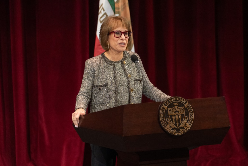 Carol Folt stands in front of a podium for her State of the University address.