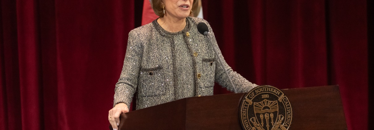 Carol Folt stands in front of a podium for her State of the University address.