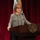 Carol Folt stands in front of a podium for her State of the University address.