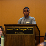 Senator Jeremiah Boisrond stands behind a podium.