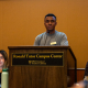 Senator Jeremiah Boisrond stands behind a podium.